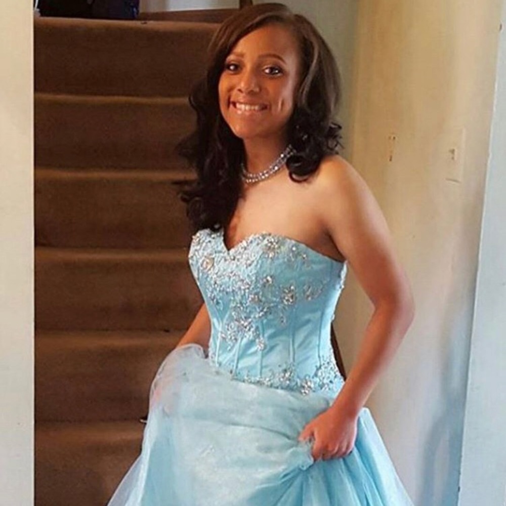 A turquoise baddazzled prom dress.